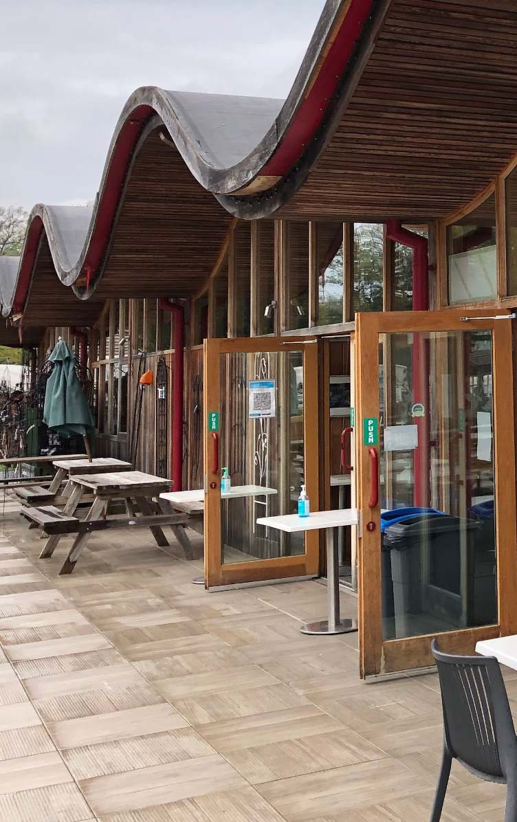 The new visitor building extension at Batsford Arboretum: timber frame and undulating roof over the garden terrace cafe